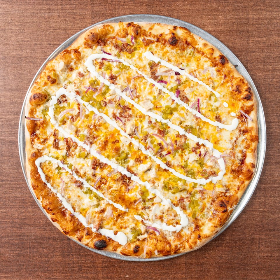 Grampie's Pizzeria's chicken bacon ranch pizza, topped with red onions and green peppers.